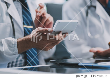 Group of medical practitioners working together and analyzing medical scan in the hospital Group of medical practitioners working together and analyzing medical scan in the hospital 119740626
