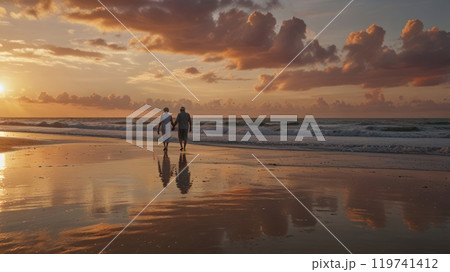 elderly couple walking at the beach 119741412