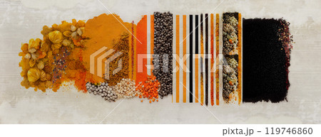 A collage of loose spices and colorful textures, dominated by orange tones 119746860