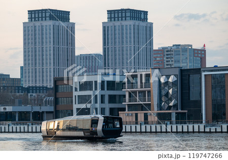 Electric river tram on the Moskva River at sunset on an autumn evening. 119747266