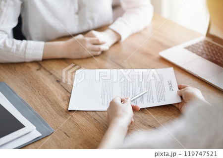 Businesswoman lawyer pointing into contract special points admitting something for colleague or client at the wooden desk in office. Business people teamwork and partnership, meeting concept 119747521