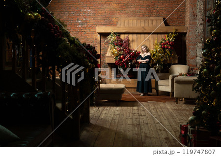 fireplace tree new woman young year christmas alone holiday celebration girl home cozy 119747807