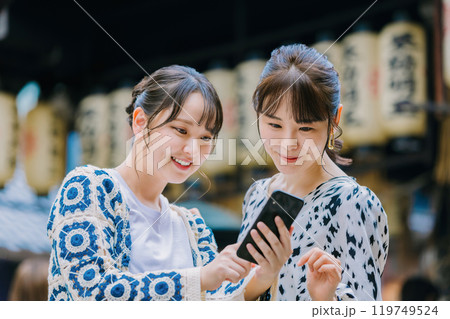 大阪観光で友達とスマホを見る女性 大阪観光で友達とスマホを見る女性 119749524