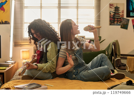 Enjoying Musical Jam Session in Cozy Bedroom Setting Enjoying Musical Jam Session in Cozy Bedroom Setting 119749666