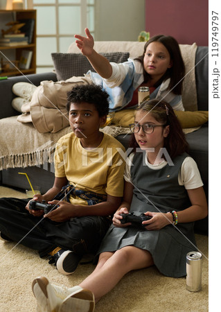Playing Video Games with Friends in Cozy Living Room 119749797