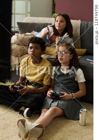 Children Playing Video Games On Living Room Floor Children Playing Video Games On Living Room Floor 119749798