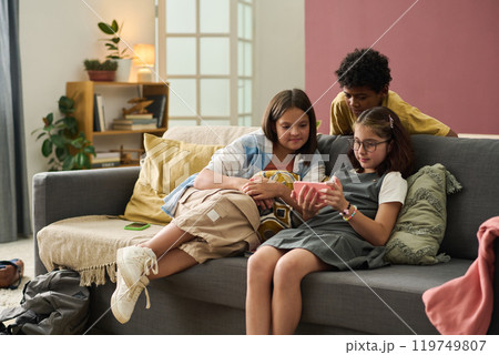 Three Kids Hanging Out on Sofa in Cozy Living Room Three Kids Hanging Out on Sofa in Cozy Living Room 119749807