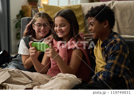 Enjoying Technology While Sitting on Couch 119749831
