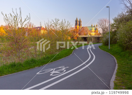 Bicycle path with view of Cathedral Basilica at sunrise, Poznan, Poland 119749998