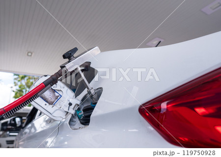 Close Up of pump nozzle Compressed Natural Gas (cng) in tank for car. Vehicle uses an energy system Natural Gas for Vehicles or NGV. Close Up of pump nozzle Compressed Natural Gas (cng) in tank for car. Vehicle uses an energy system Natural Gas for Vehicles or NGV. 119750928