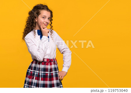 Girl with hand on chin, thoughtful expression Girl with hand on chin, thoughtful expression 119753040