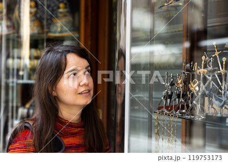 Female traveler viewing forged souvenirs in gift shop of Toledo Female traveler viewing forged souvenirs in gift shop of Toledo 119753173