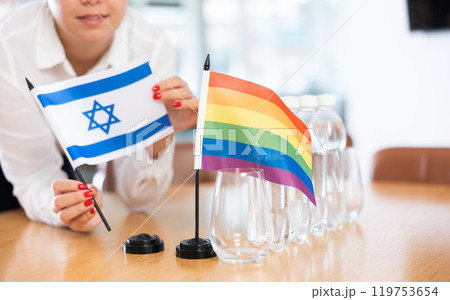 Flag of Israel and rainbow flag on negotiating table Flag of Israel and rainbow flag on negotiating table 119753654