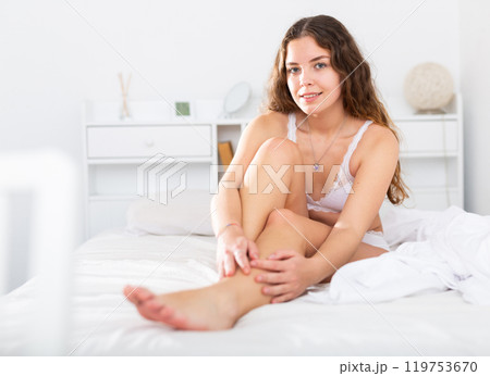 Sexy woman with long hair in underwear sitting on bed Sexy woman with long hair in underwear sitting on bed 119753670