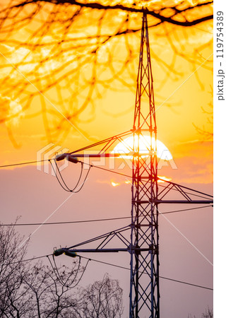 A Beautiful Sunset Behind Power Lines, Where Nature Harmoniously Meets the Industrial World 119754389