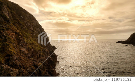 Enjoy the breathtaking view of a stunning coastal landscape with rocky cliffs and serene waters 119755152