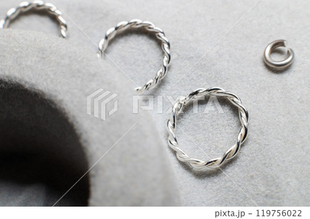 Metal jewelry elements, bracelet links lie in a storage box in a jewelry workshop 119756022