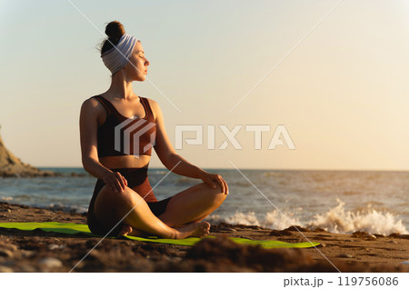 Young woman practicing yoga outdoors. Harmony and meditation concept. Healthy lifestyle Young woman practicing yoga outdoors. Harmony and meditation concept. Healthy lifestyle 119756086