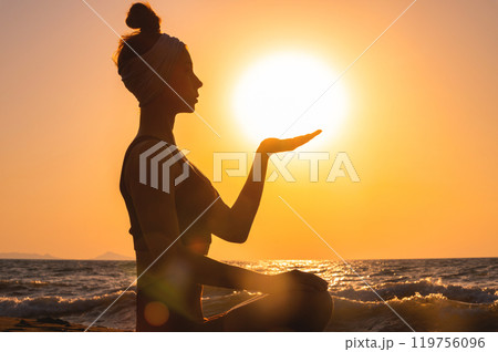 close up of man meditating with hands in gyan mudra at sunset. female hand against sun and sea, fingers showing mudra during meditation practice, calm and tranquility in nature close up of man meditating with hands in gyan mudra at sunset. female hand against sun and sea, fingers showing mudra during meditation practice, calm and tranquility in nature 119756096