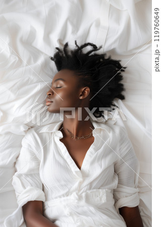 Smiling african american woman sleeping on white bed with copy space Smiling african american woman sleeping on white bed with copy space 119760649