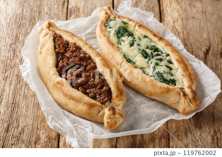 Turkish flat bread that comes stuffed with a variety of toppings, including cheese, spiced meat and spinach close-up. Horizontal 119762002