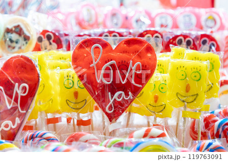 Heart lollipops for Valentine's Day displayed in the shop window for sale. Close-up. Sweets and candies for the holiday 119763091