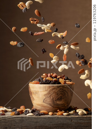 Flying dried fruits and nuts. 119763206