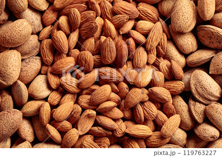 Peeled and unpeeled almonds. Peeled and unpeeled almonds. 119763227