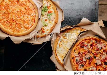 Assortment of delicious pizzas with various toppings, perfect for delivery or casual dining 119767060