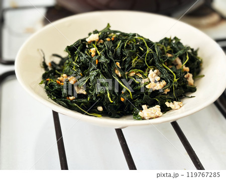 Close up Thai-Chinese food called Pad Bai Por of stir-fried Mulukhiyah leaves with ground pork. Homemade food local Thai-Chinese menu. Close up Thai-Chinese food called Pad Bai Por of stir-fried Mulukhiyah leaves with ground pork. Homemade food local Thai-Chinese menu. 119767285