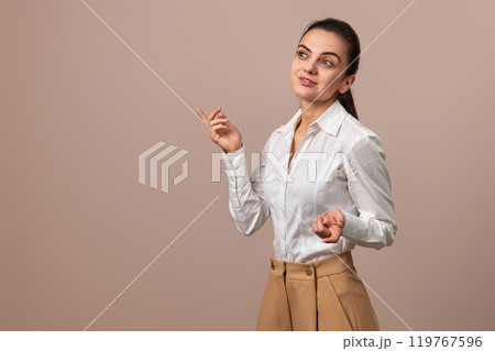 caucasian businesswoman lady in white shirt and beige pants, copy space 119767596