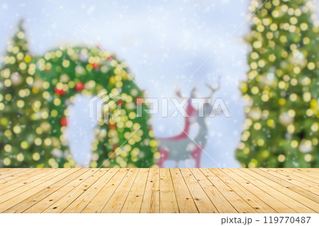 Empty wood table top with blur Christmas tree with bokeh light background Empty wood table top with blur Christmas tree with bokeh light background 119770487