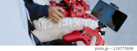 Website banner with unrecognizable girl holding red plastic joystick with smartphone 119775606