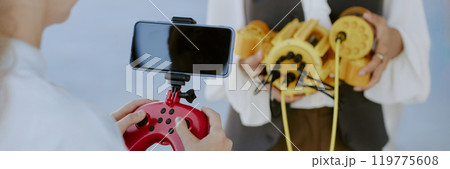 Website banner of unrecognizable girl holding red joystick with set smartphone 119775608