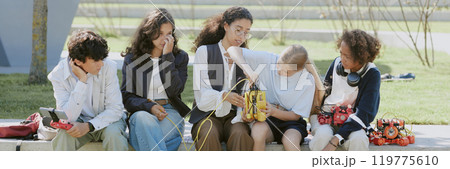 Website banner of young robotics teacher telling about robots while biracial students looking at it 119775610