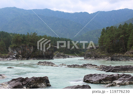 Turquoise Katun River. View from the river bank to the old ruined bridge. Summer landscape Turquoise Katun River. View from the river bank to the old ruined bridge. Summer landscape 119776230