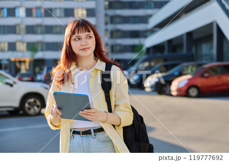Young female college student with digital tablet, outdoors Young female college student with digital tablet, outdoors 119777692