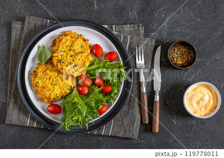 pumpkin carrot potato patties on plate, top view pumpkin carrot potato patties on plate, top view 119778011
