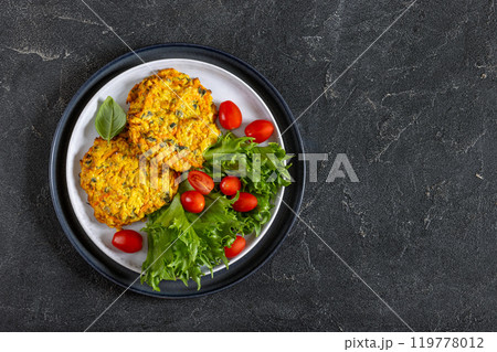 pumpkin carrot potato patties on plate, top view 119778012