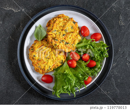 pumpkin carrot potato patties on plate, top view pumpkin carrot potato patties on plate, top view 119778013