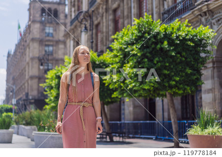 Female tourist in the central square of Mexico City, Zocalo. Cultural exploration, travel, and historic architecture concept Female tourist in the central square of Mexico City, Zocalo. Cultural exploration, travel, and historic architecture concept 119778184