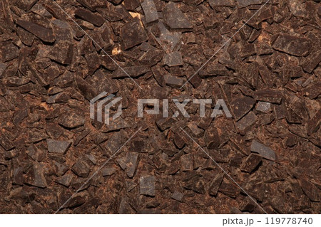 Grated cocoa background, top view, texture. Grated cocoa is one of the ingredients in making chocolate at home. Close-up of crushed cocoa, top view. 119778740