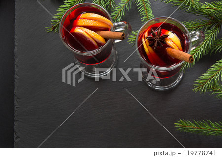 Hot Mulled wine with cinnamon and christmas tree on black slate dish. Top view and copy space. 119778741
