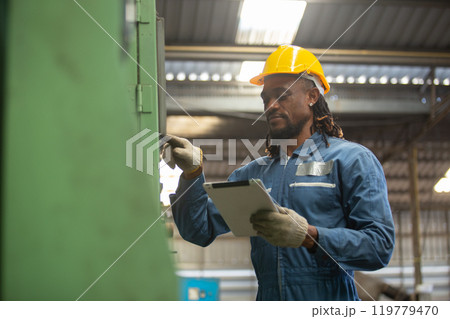 Male african american workers wear yellow hard hat holding wrench working on repairing factory machinery. man maintenance Factory, mechanical repairman concept. 119779470