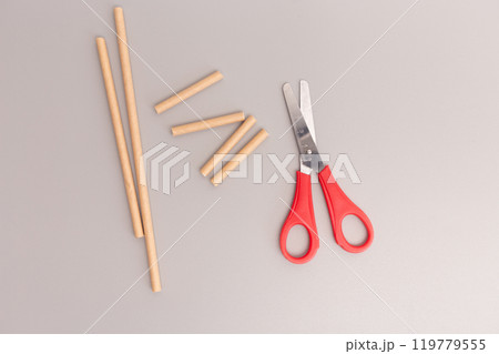 scissors cutting paper straw step in DIY project quick assembly creative process for making simplified children toy, 119779555