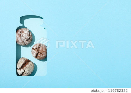 Appetizing crinkle cookies, on a blue background. Appetizing crinkle cookies, on a blue background. 119782322
