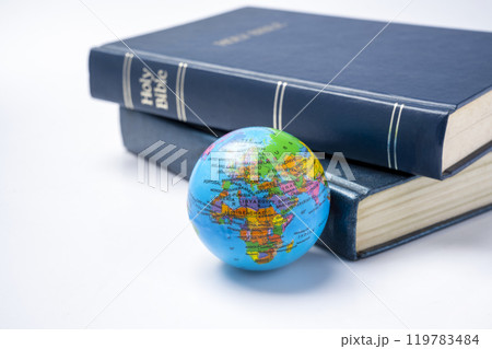 Book of Holy Bible with globe. It is laying on white background. Symbol of faith and worship in God 119783484