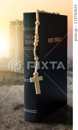 Book of Holy Bible and rosary beads. Symbol of faith and worship in God 119783625