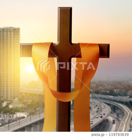 Religion christianity cross and orange ribbon with sunlight background. Symbol of faith and worship in God 119783639