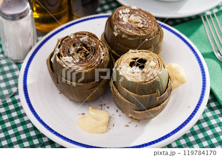 Steamed artichokes with sauce aioli 119784170